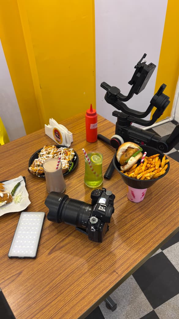 Camera and gimbal resting on a table between takes